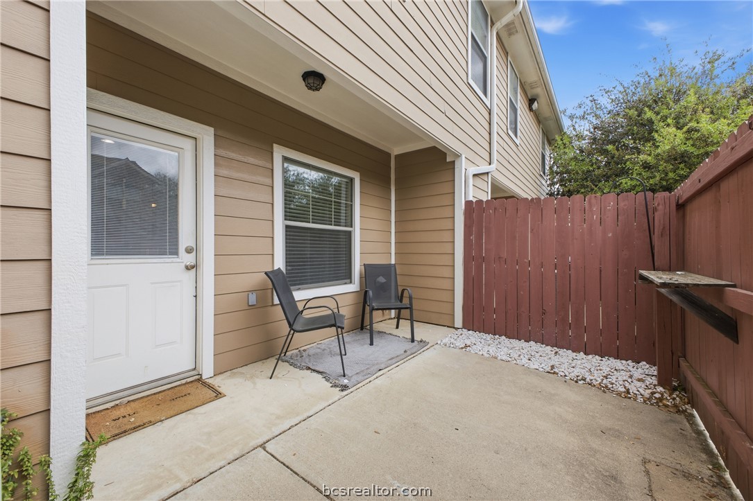 1000 Spring Loop, Unit 2105 College Station, TX 77840 - Photo 18 of 22 a backyard of a house with chairs and wooden fence