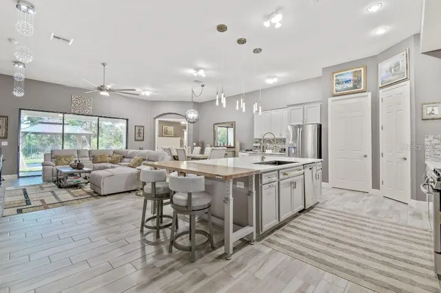 a kitchen with stainless steel appliances granite countertop a refrigerator and cabinets