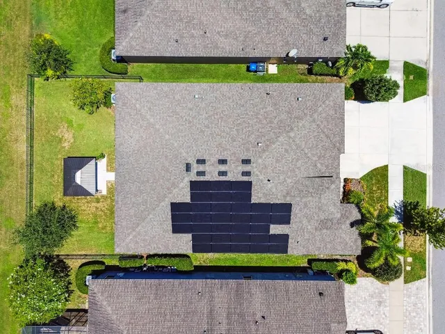 a view of a hallway view with wooden floor and a living room