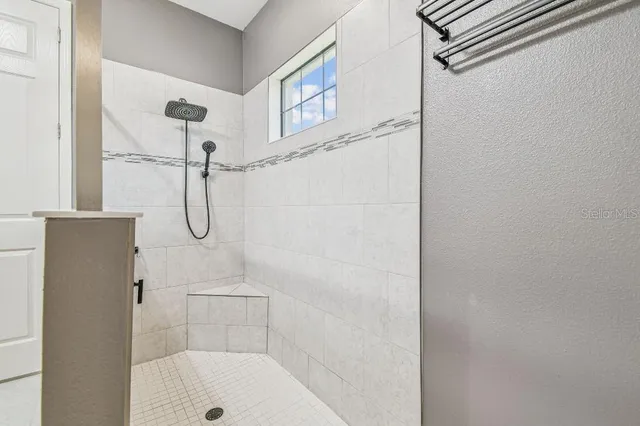 a view of backyard with a table and chairs and potted plants