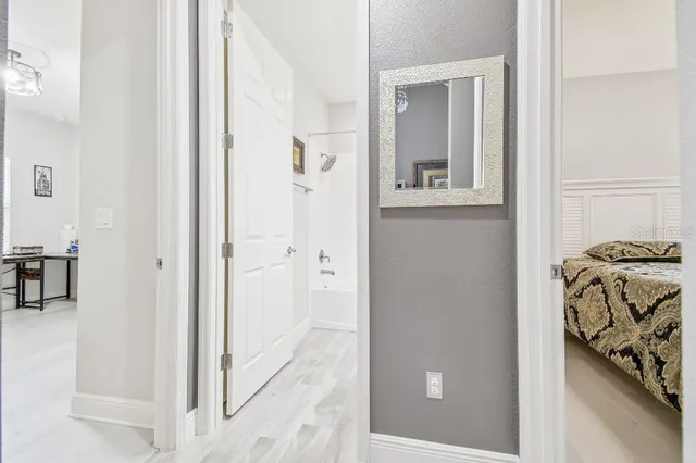 a bathroom with a granite countertop sink a toilet and a mirror