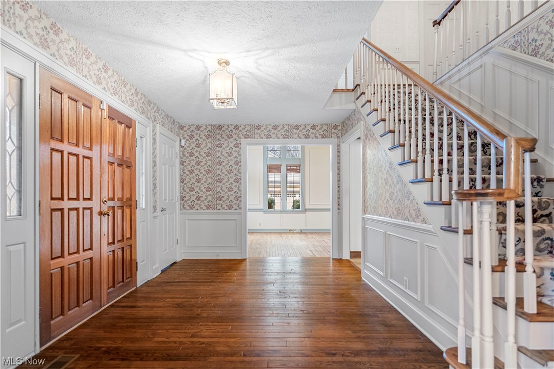 4017 Bramshaw Road Northwest Canton, OH 44718 - Photo 4 of 42 Beautiful foyer entryway with double doors, hardwood floors and stairs leading to second floor