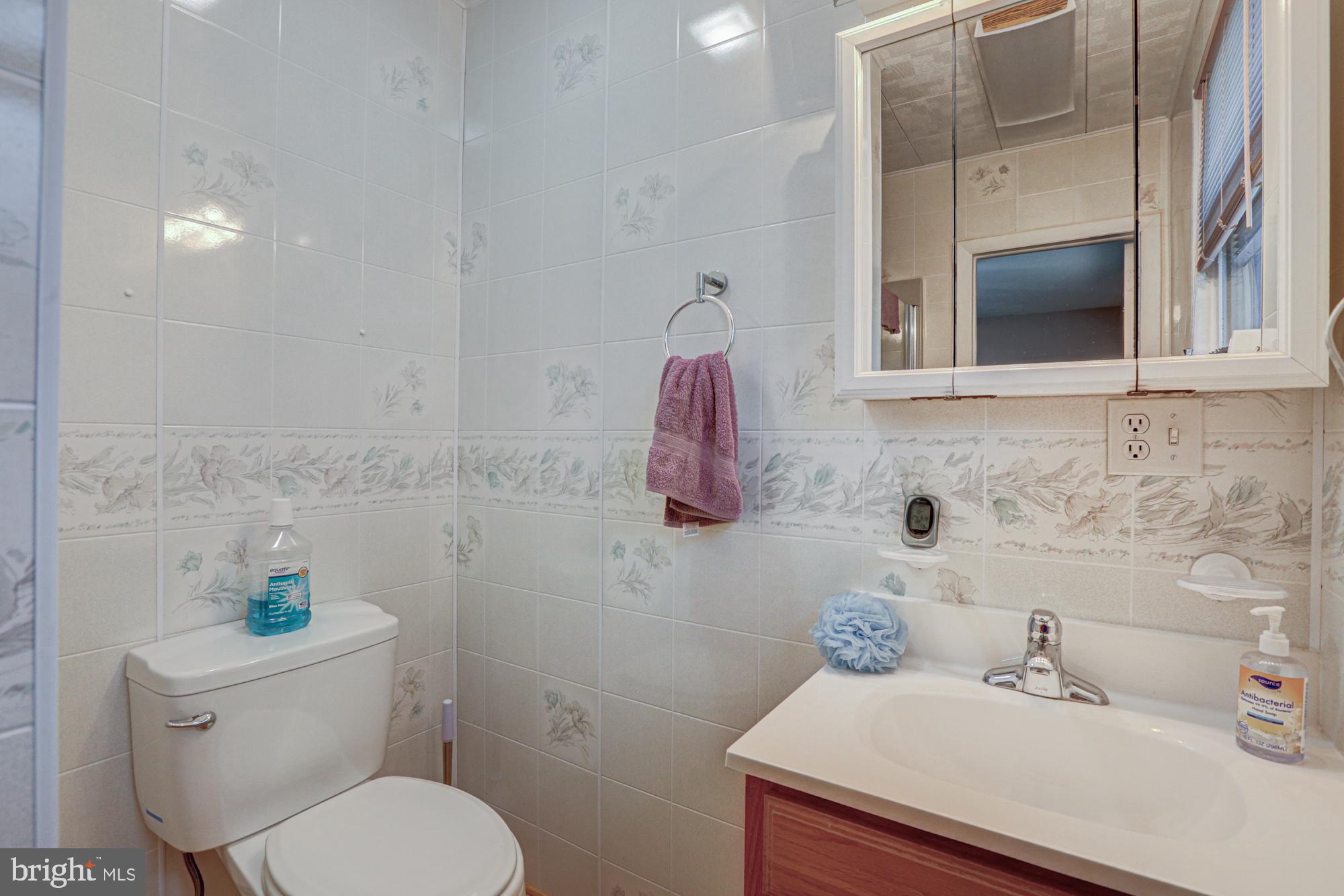 4 Old Forge Road Pennsville, NJ 08070 - Photo 42 of 61 a bathroom with a sink mirror and toilet