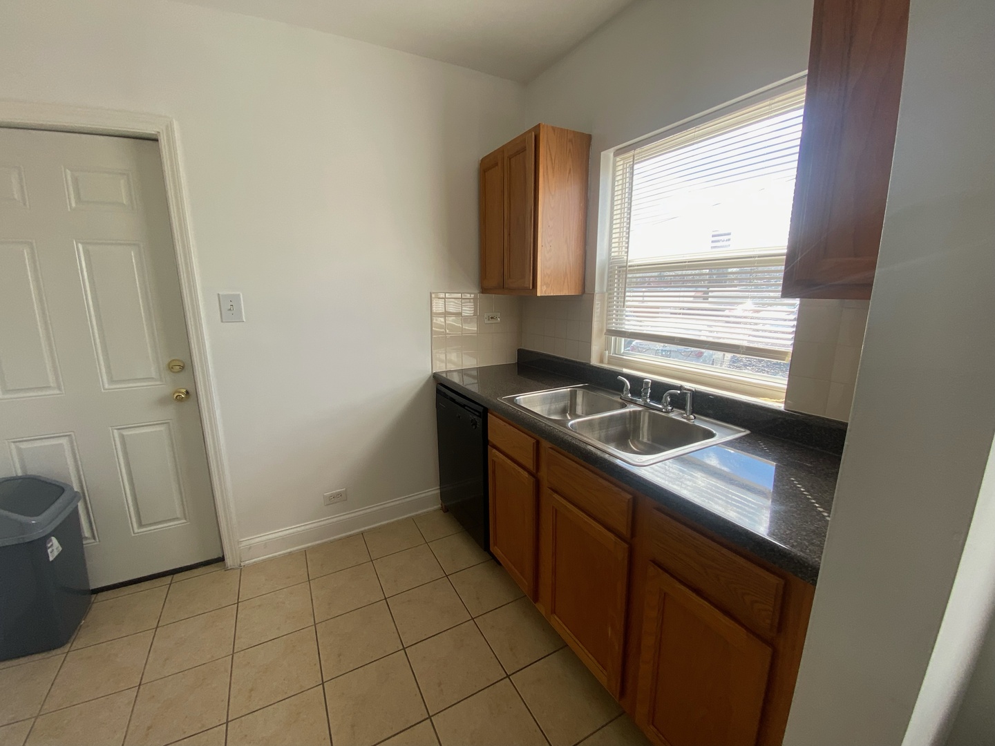 2419 North Oak Park Avenue, Unit 2C Chicago, IL 60707 - Photo 5 of 7 a kitchen with a sink cabinets and a window