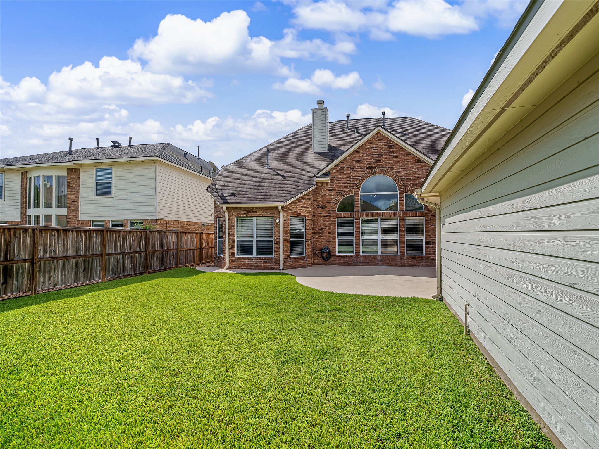 2210 Fox Path Katy, TX 77494 - Photo 46 of 47 The entire perimeter is enclosed by a tall, sturdy wooden privacy fence, creating a secure and quiet sanctuary away from neighbors.