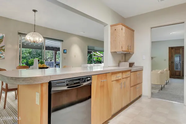 a kitchen with stainless steel appliances granite countertop a sink a stove and a wooden floors