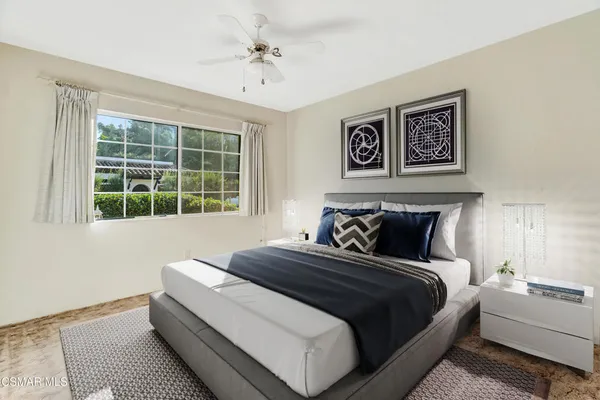 a bedroom with a large bed and a window