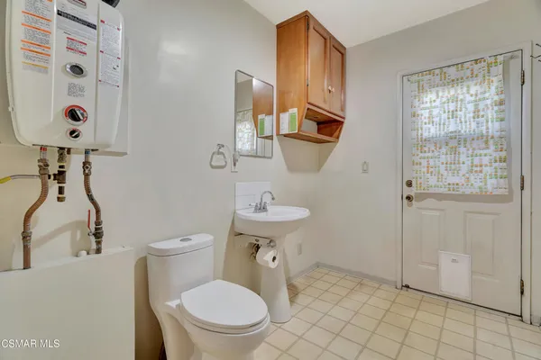 a white toilet sitting next to a bathroom sink