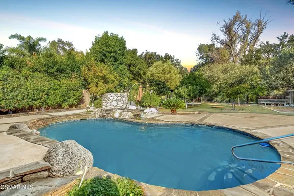 a view of a backyard with sitting area