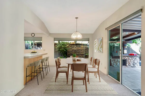 a view of a dining room with furniture window and outside view