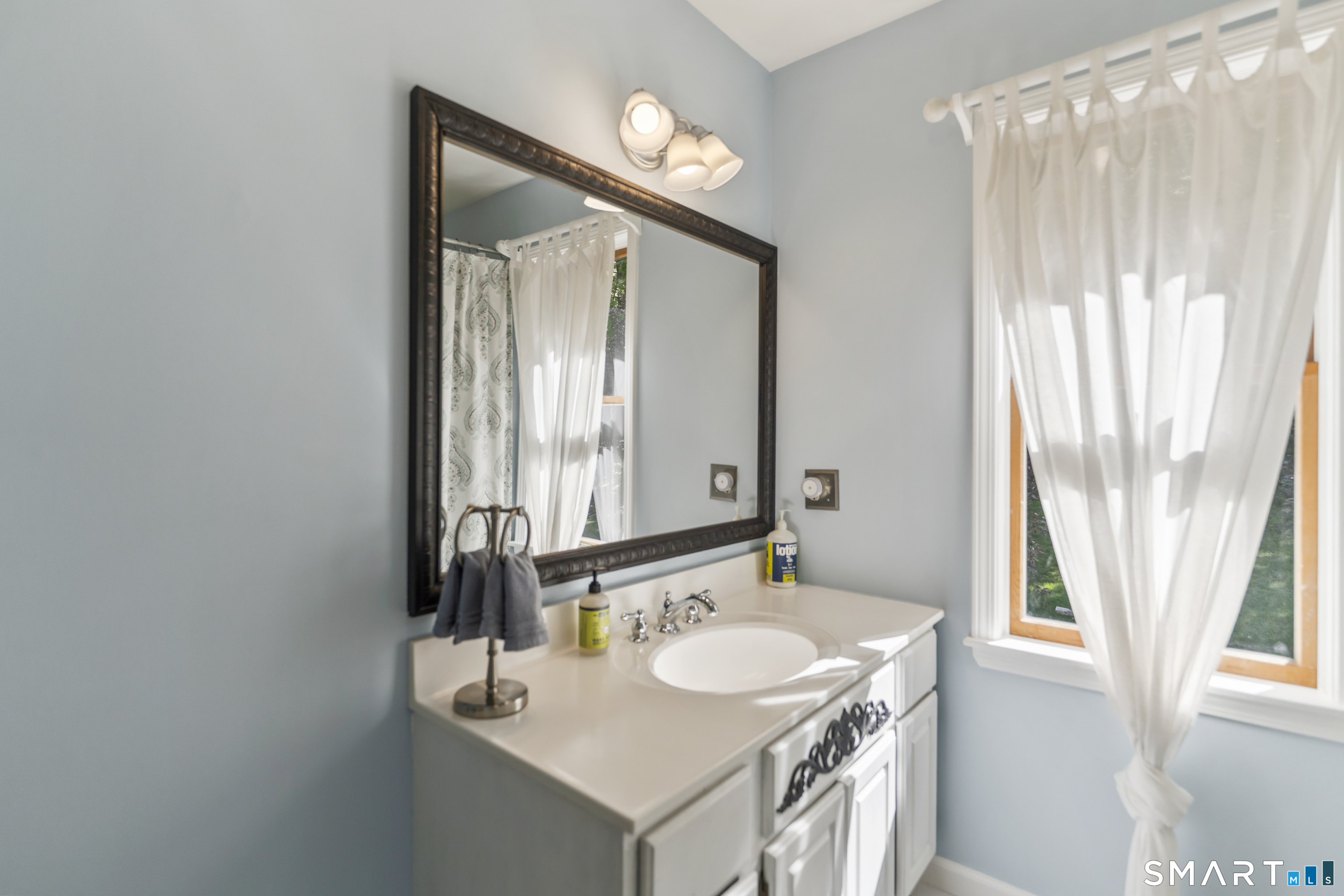 18 Gelding Hill Road Newtown, CT 06482 - Photo 32 of 40 a bathroom with a sink and a mirror
