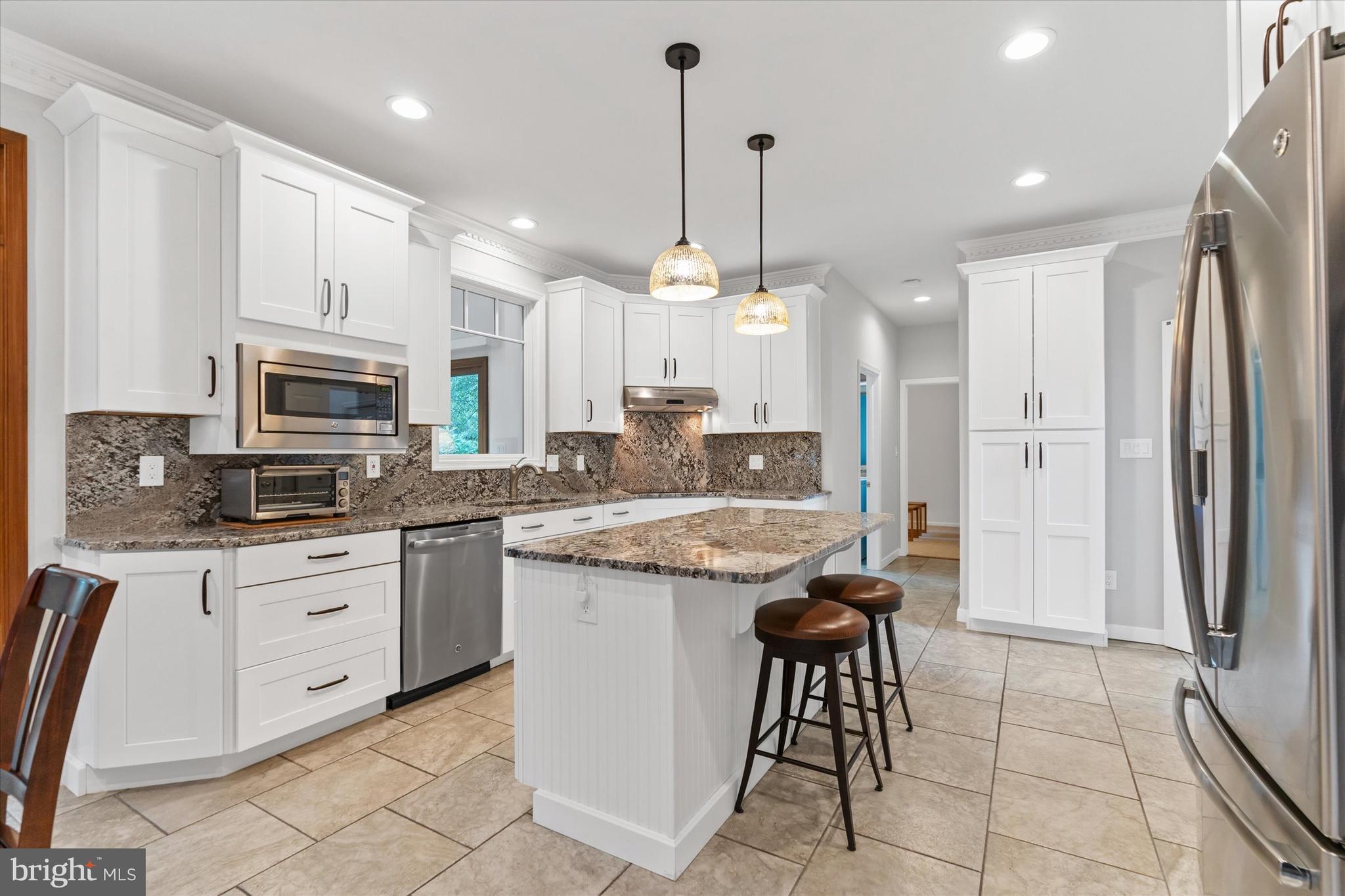 216 South Pond Road Hockessin, DE 19707 - Photo 11 of 61 a kitchen with stainless steel appliances granite countertop a stove a sink a refrigerator and a microwave