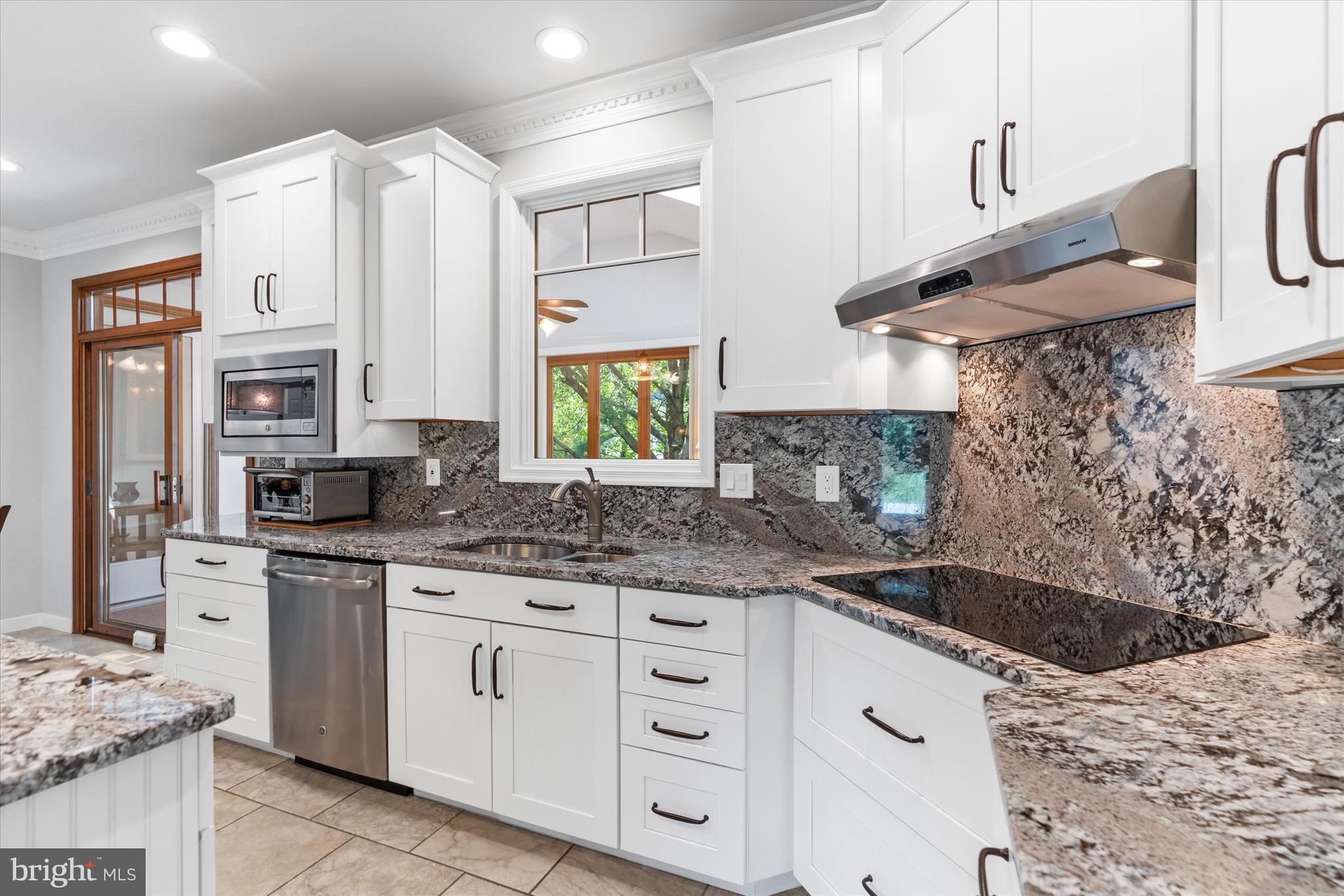 216 South Pond Road Hockessin, DE 19707 - Photo 12 of 61 a kitchen with stainless steel appliances granite countertop a sink stove and cabinets