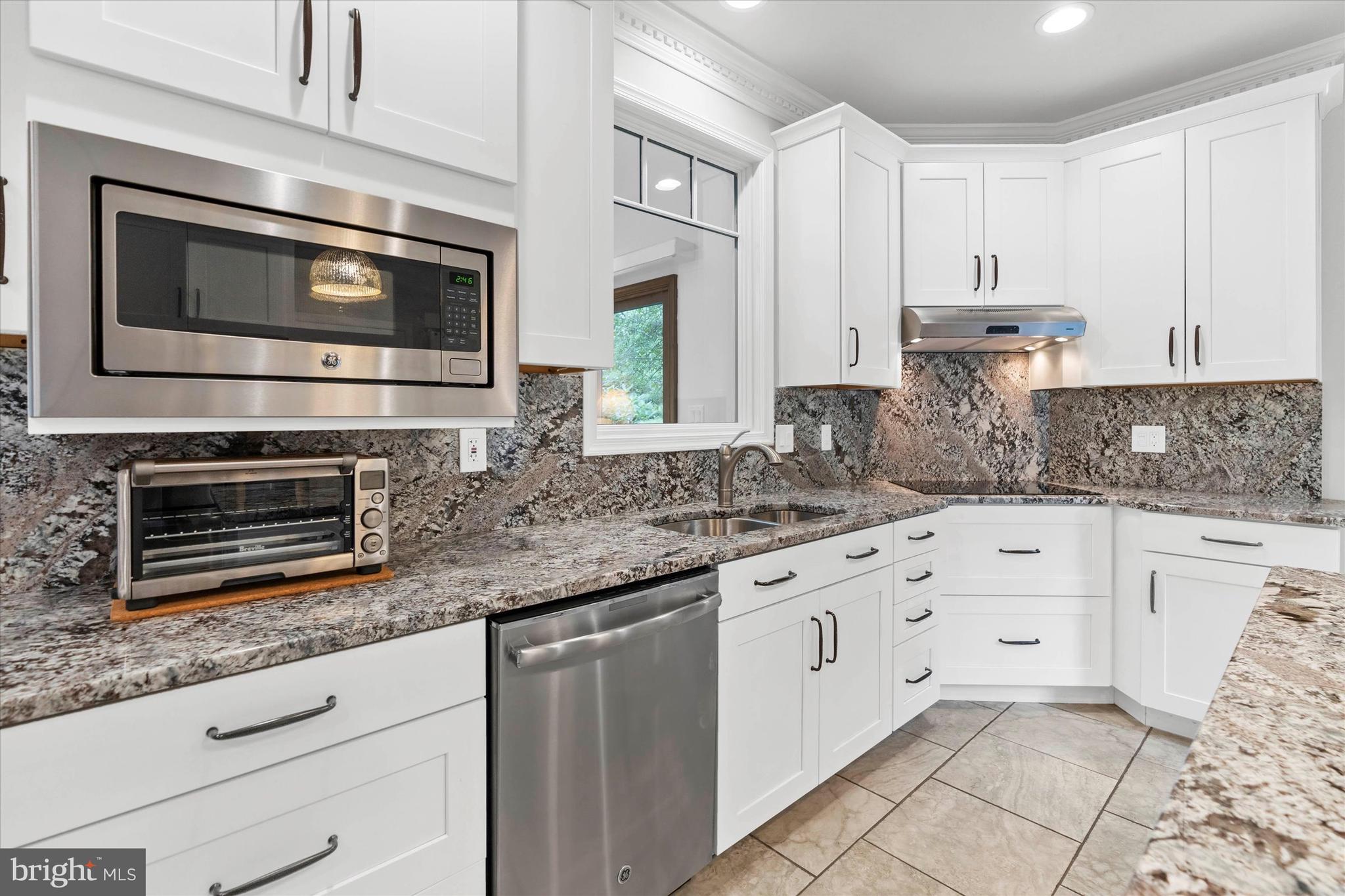 216 South Pond Road Hockessin, DE 19707 - Photo 14 of 61 a kitchen with granite countertop white cabinets stainless steel appliances and a counter space