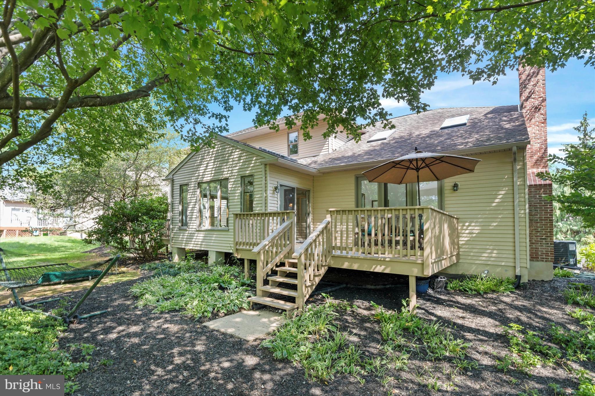216 South Pond Road Hockessin, DE 19707 - Photo 46 of 61 a wooden bench sitting in front of a house