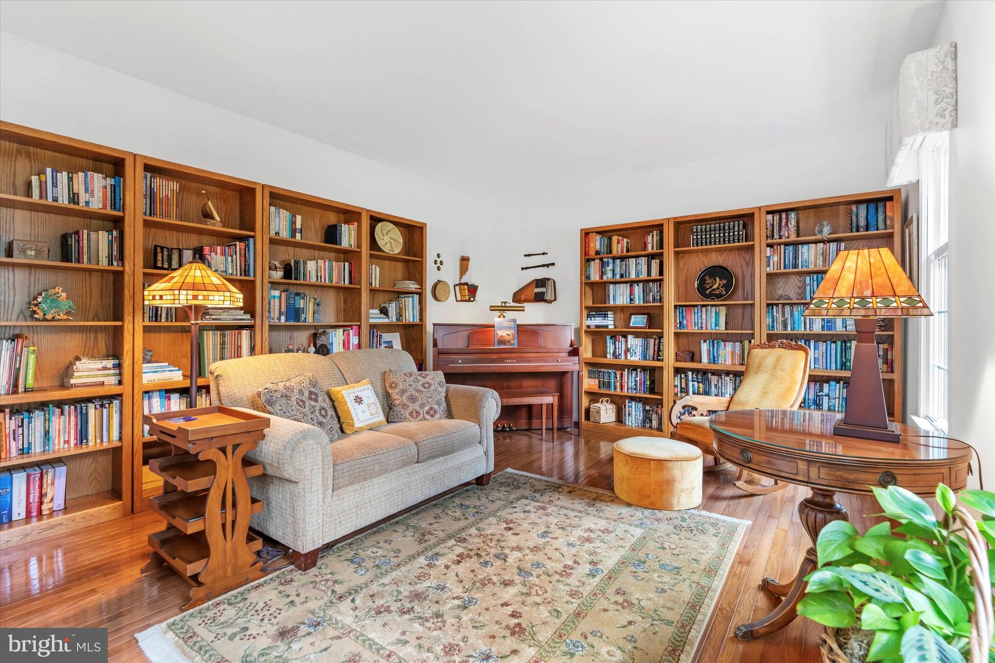 216 South Pond Road Hockessin, DE 19707 - Photo 6 of 61 a living room with furniture a rug and a book shelf
