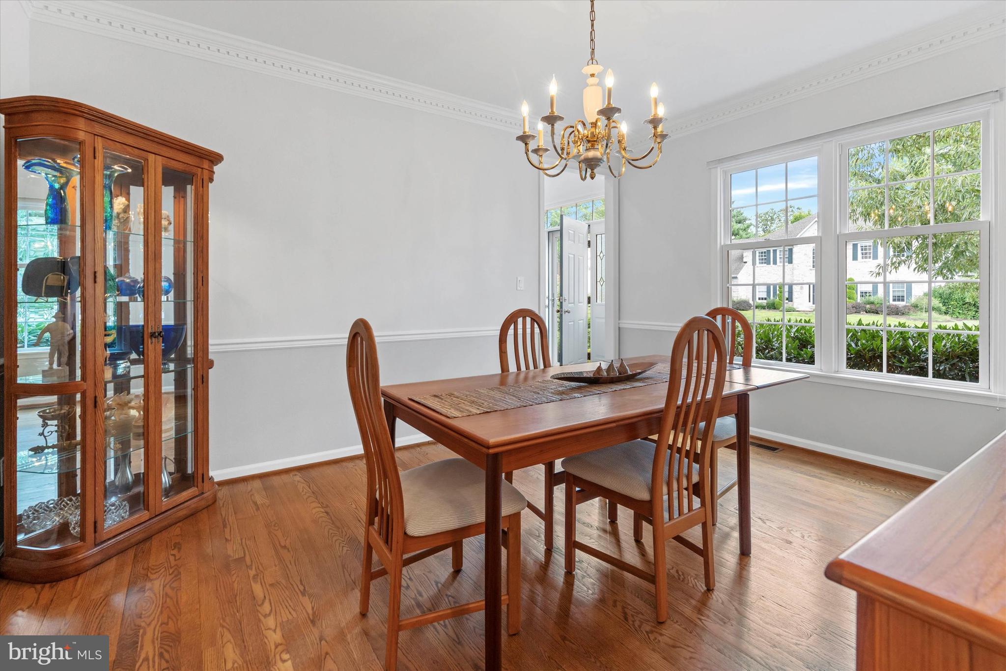 216 South Pond Road Hockessin, DE 19707 - Photo 7 of 61 a view of a dining room with furniture a chandelier and wooden floor