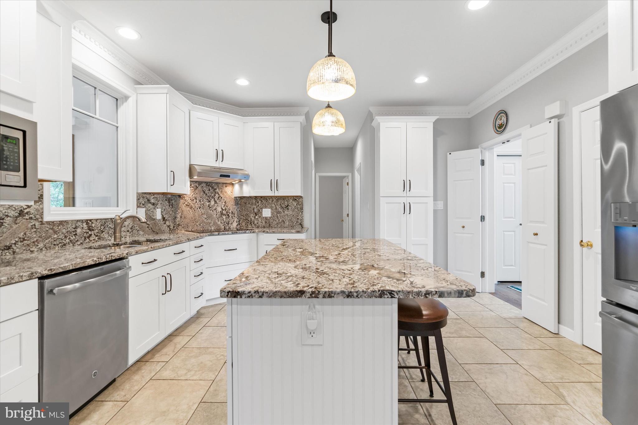 216 South Pond Road Hockessin, DE 19707 - Photo 9 of 61 a kitchen with stainless steel appliances granite countertop a sink stove and refrigerator