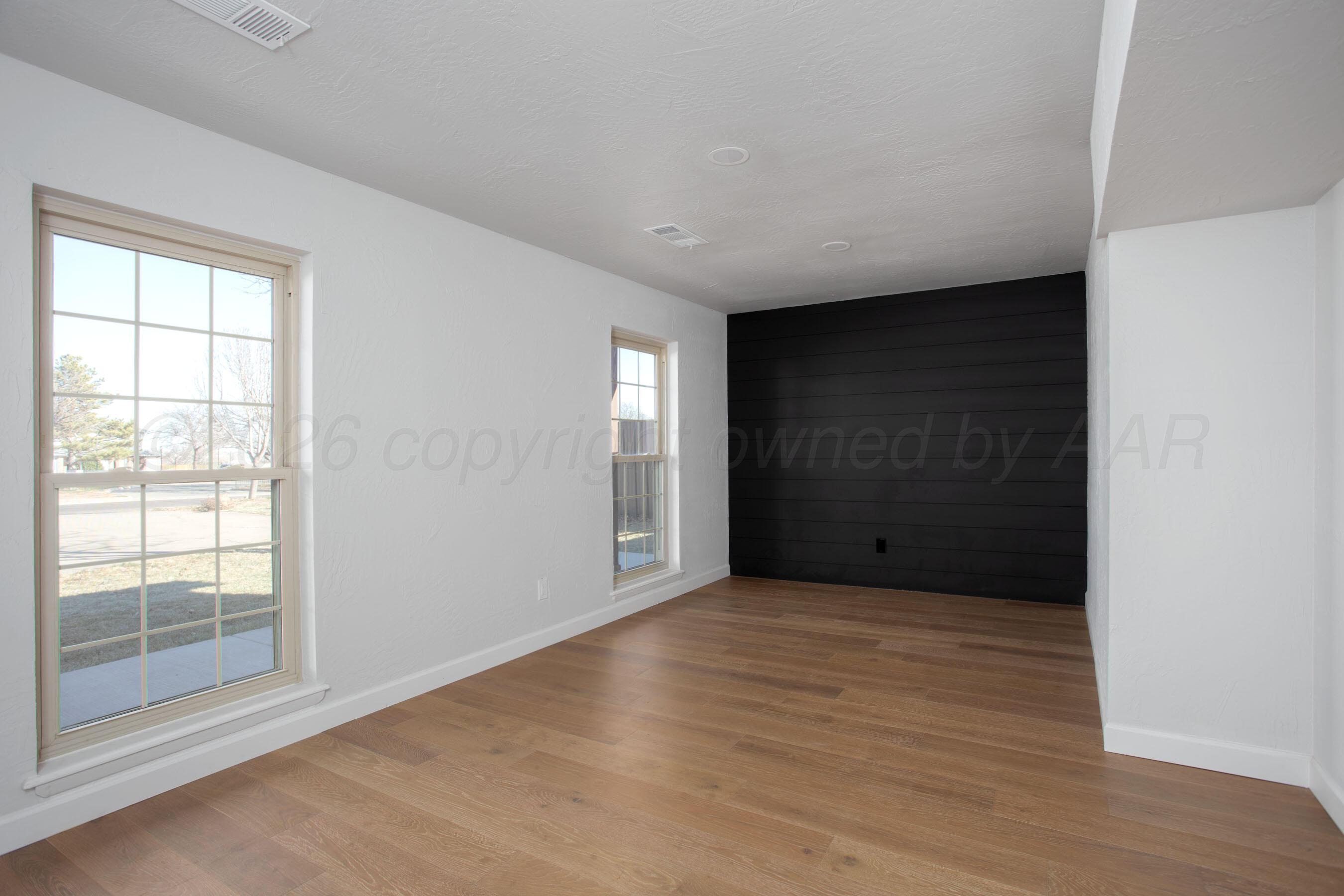 4217 West Farmers Avenue Amarillo, TX 79110 - Photo 11 of 38 a view of an empty room with wooden floor and a window