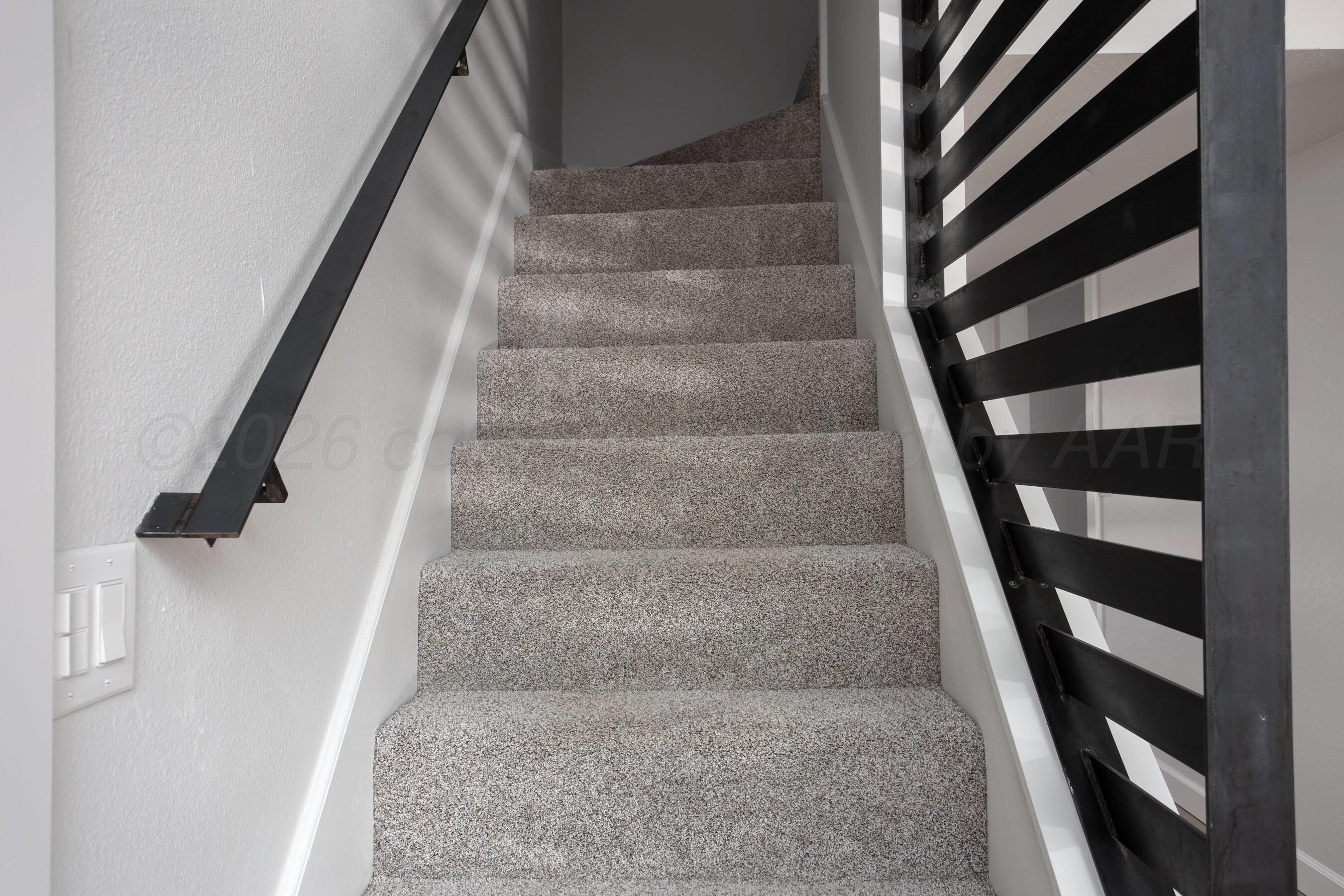 4217 West Farmers Avenue Amarillo, TX 79110 - Photo 13 of 38 a view of staircase with white walls and a window