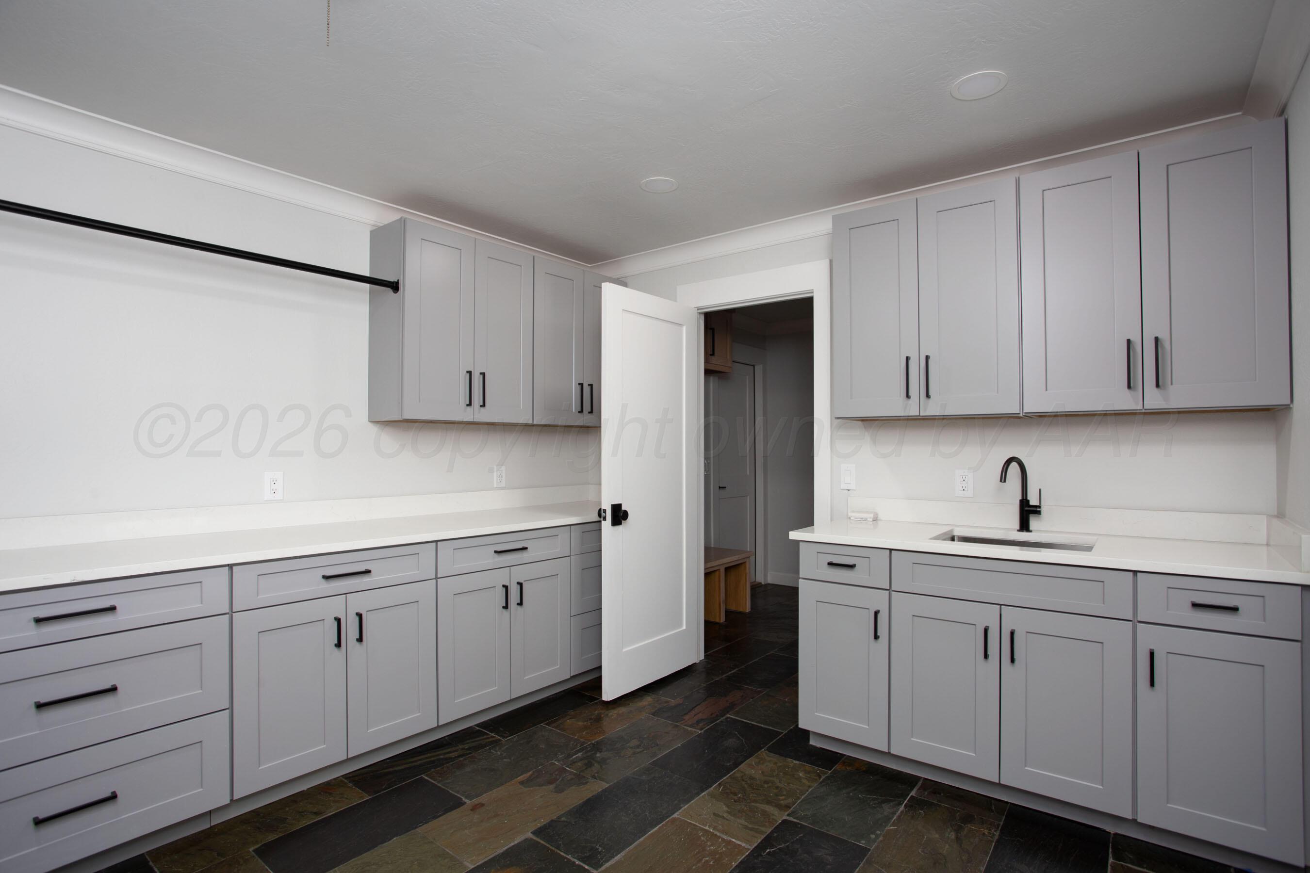 4217 West Farmers Avenue Amarillo, TX 79110 - Photo 15 of 38 a kitchen with white cabinets sink and dishwasher