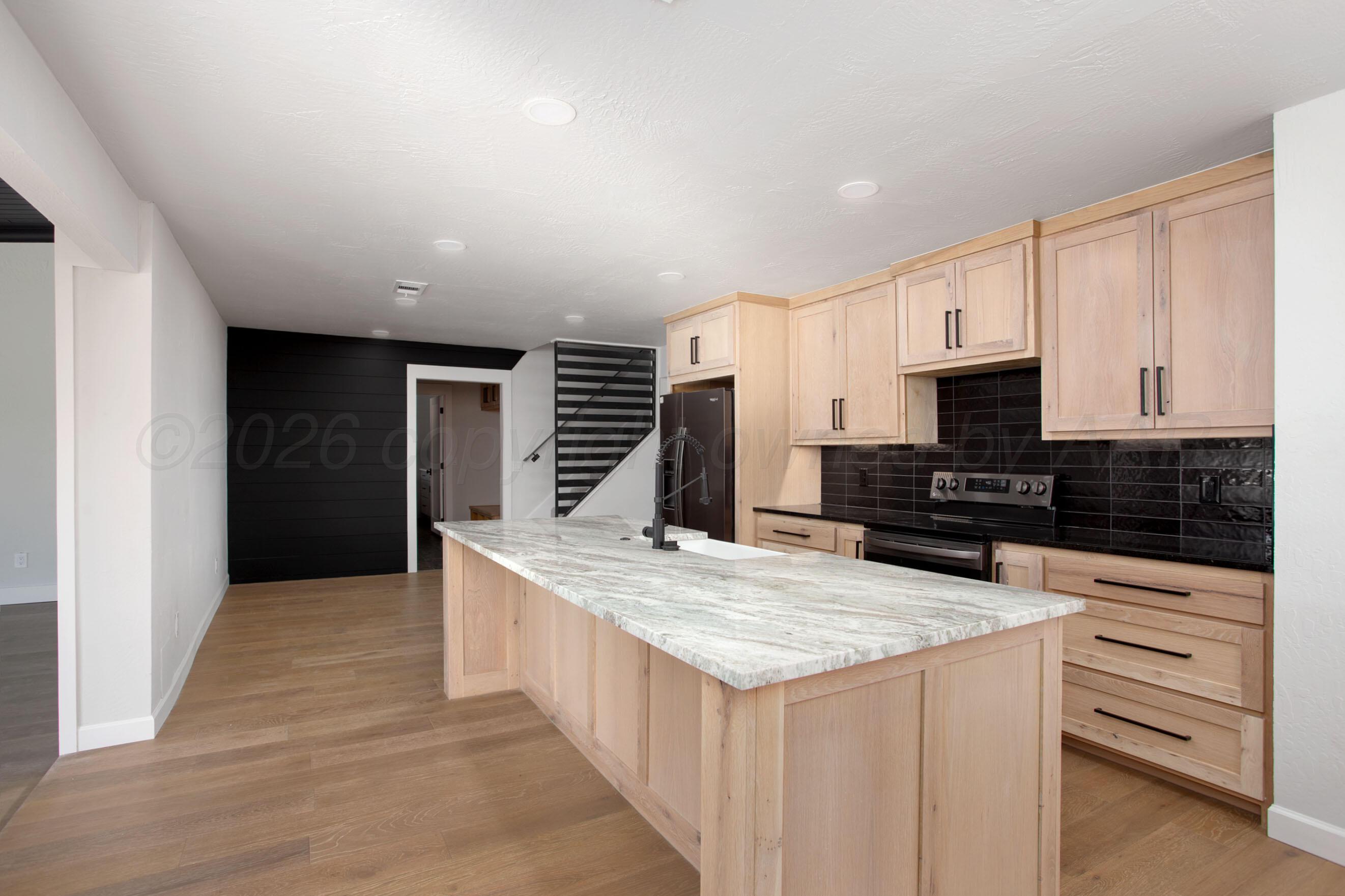 4217 West Farmers Avenue Amarillo, TX 79110 - Photo 2 of 38 a kitchen with granite countertop a sink and cabinets
