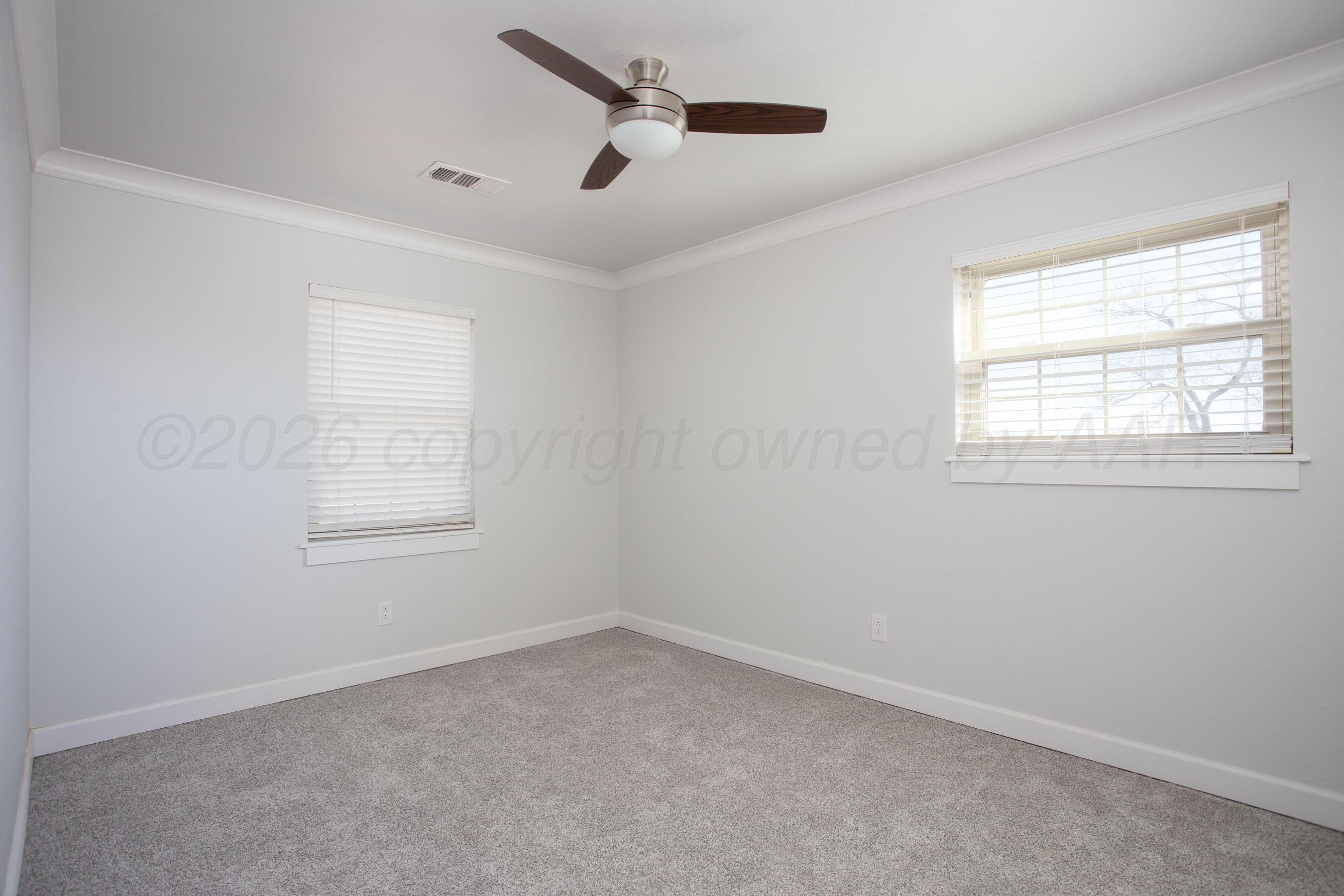4217 West Farmers Avenue Amarillo, TX 79110 - Photo 21 of 38 an empty room with a window and a fan