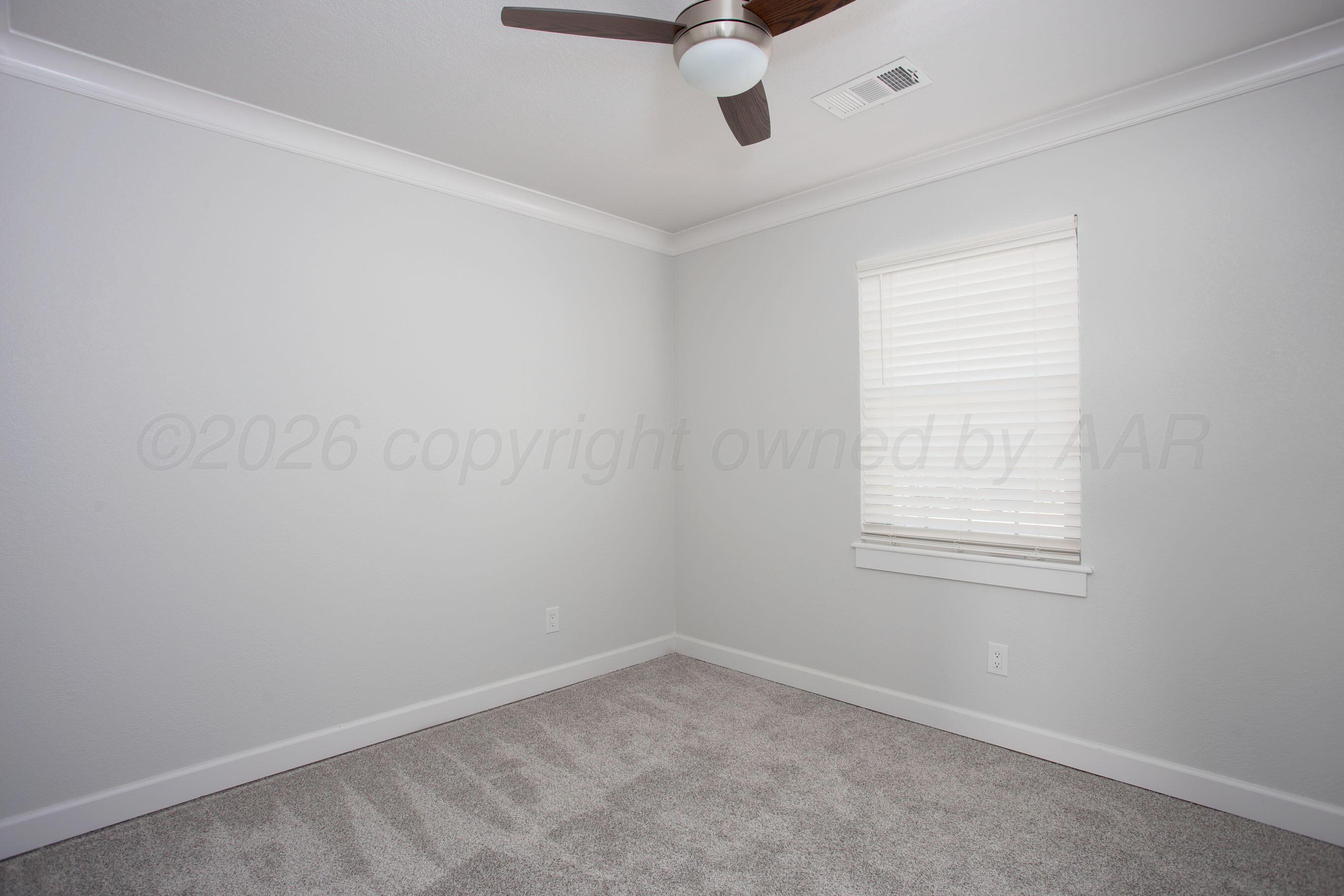 4217 West Farmers Avenue Amarillo, TX 79110 - Photo 23 of 38 an empty room with a window and a fan
