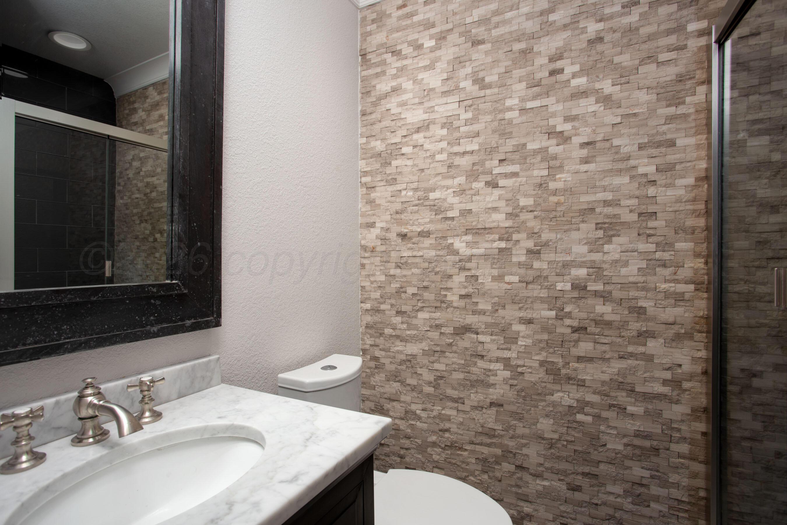 4217 West Farmers Avenue Amarillo, TX 79110 - Photo 25 of 38 a bathroom with a granite countertop toilet sink and mirror