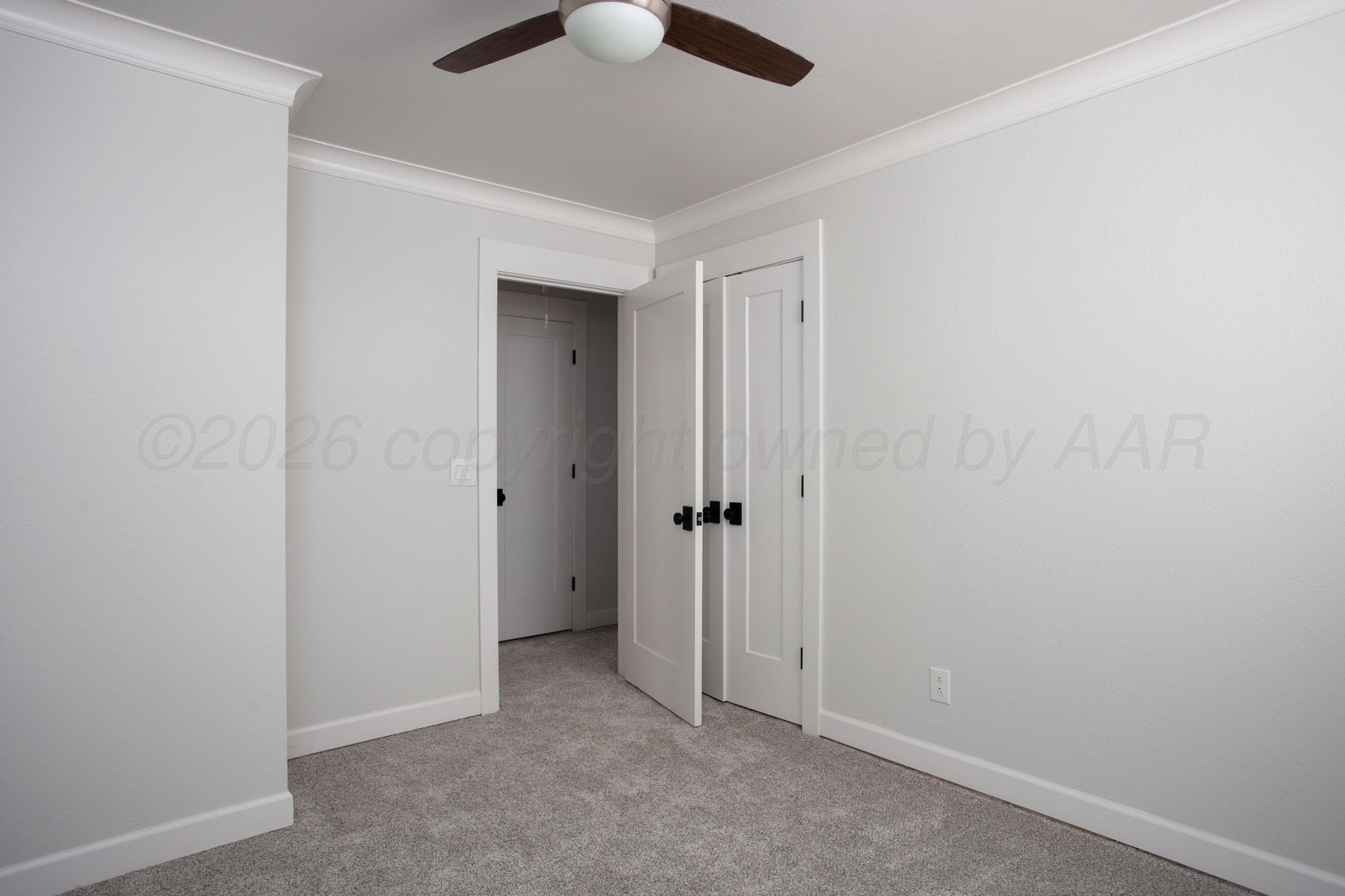 4217 West Farmers Avenue Amarillo, TX 79110 - Photo 27 of 38 an empty room with a ceiling fan and carpet