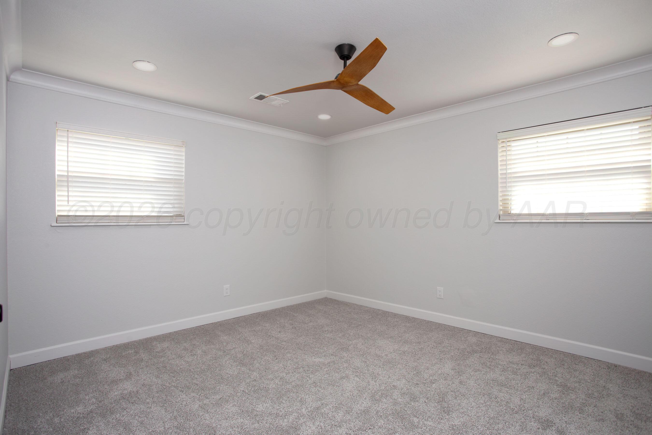 4217 West Farmers Avenue Amarillo, TX 79110 - Photo 29 of 38 an empty room with a window and a ceiling fan