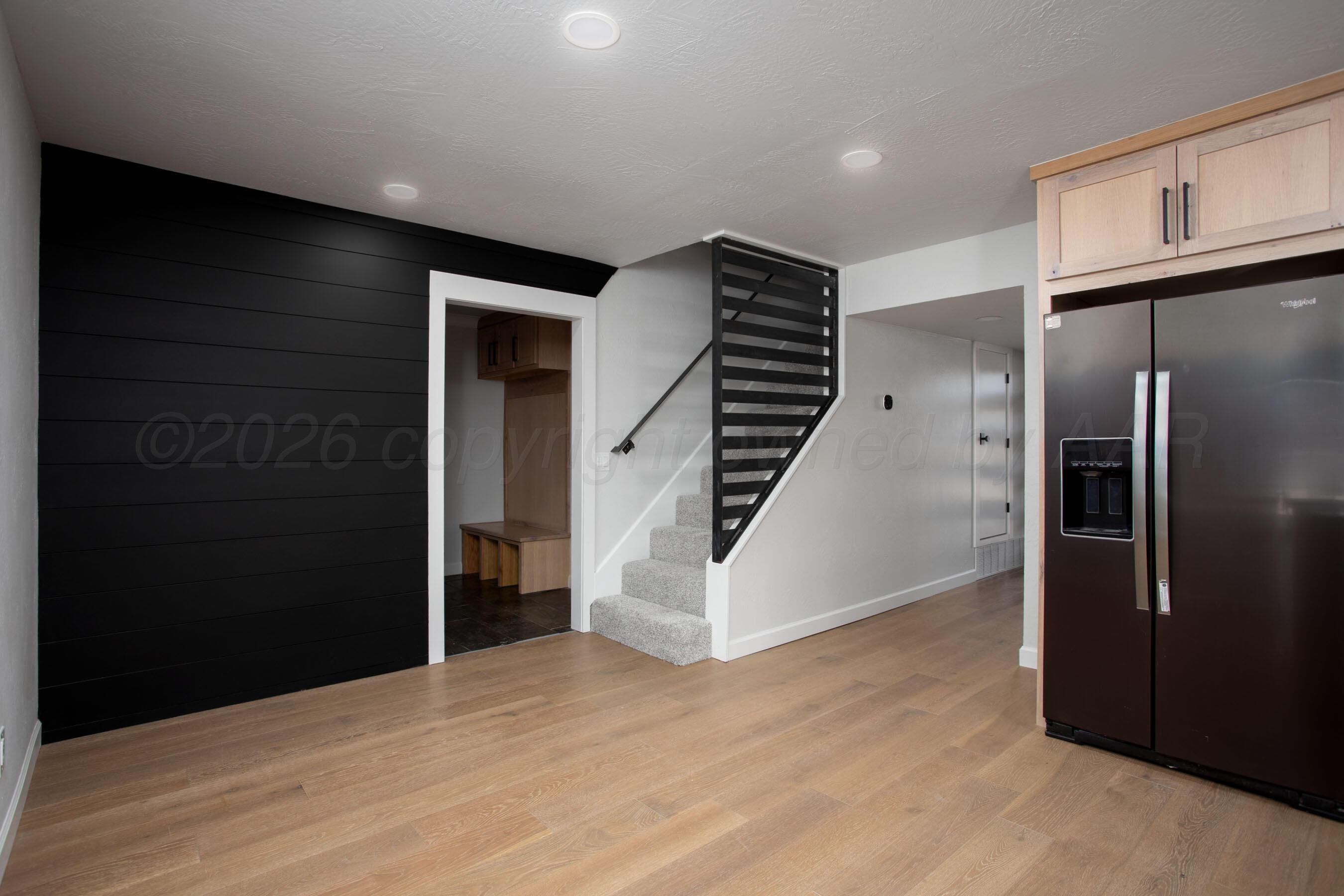 4217 West Farmers Avenue Amarillo, TX 79110 - Photo 4 of 38 a view of a kitchen with refrigerator and wooden floor