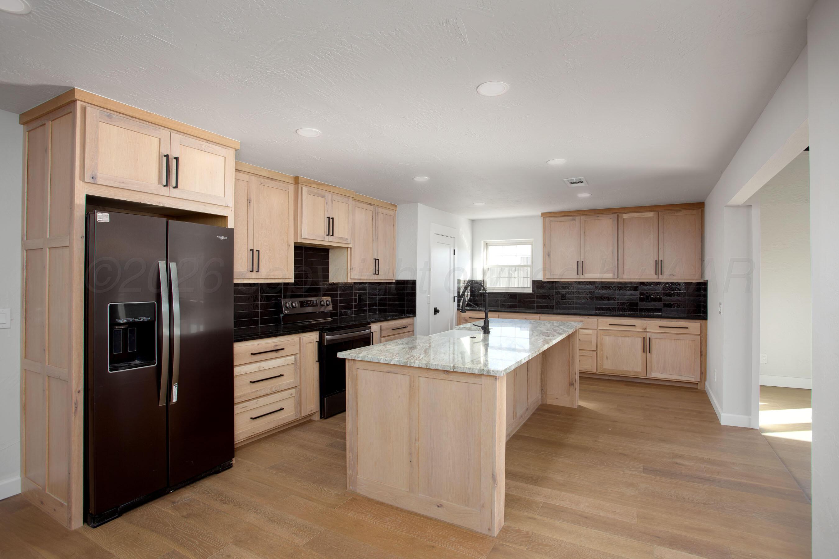 4217 West Farmers Avenue Amarillo, TX 79110 - Photo 5 of 38 a large kitchen with cabinets stainless steel appliances and a counter space