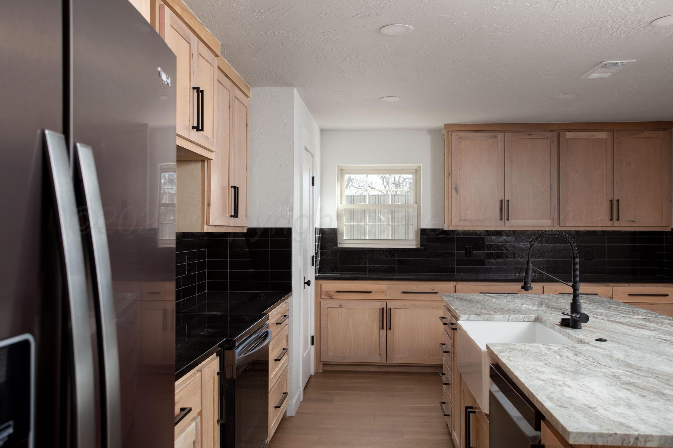 4217 West Farmers Avenue Amarillo, TX 79110 - Photo 6 of 38 a kitchen with a sink stove and refrigerator