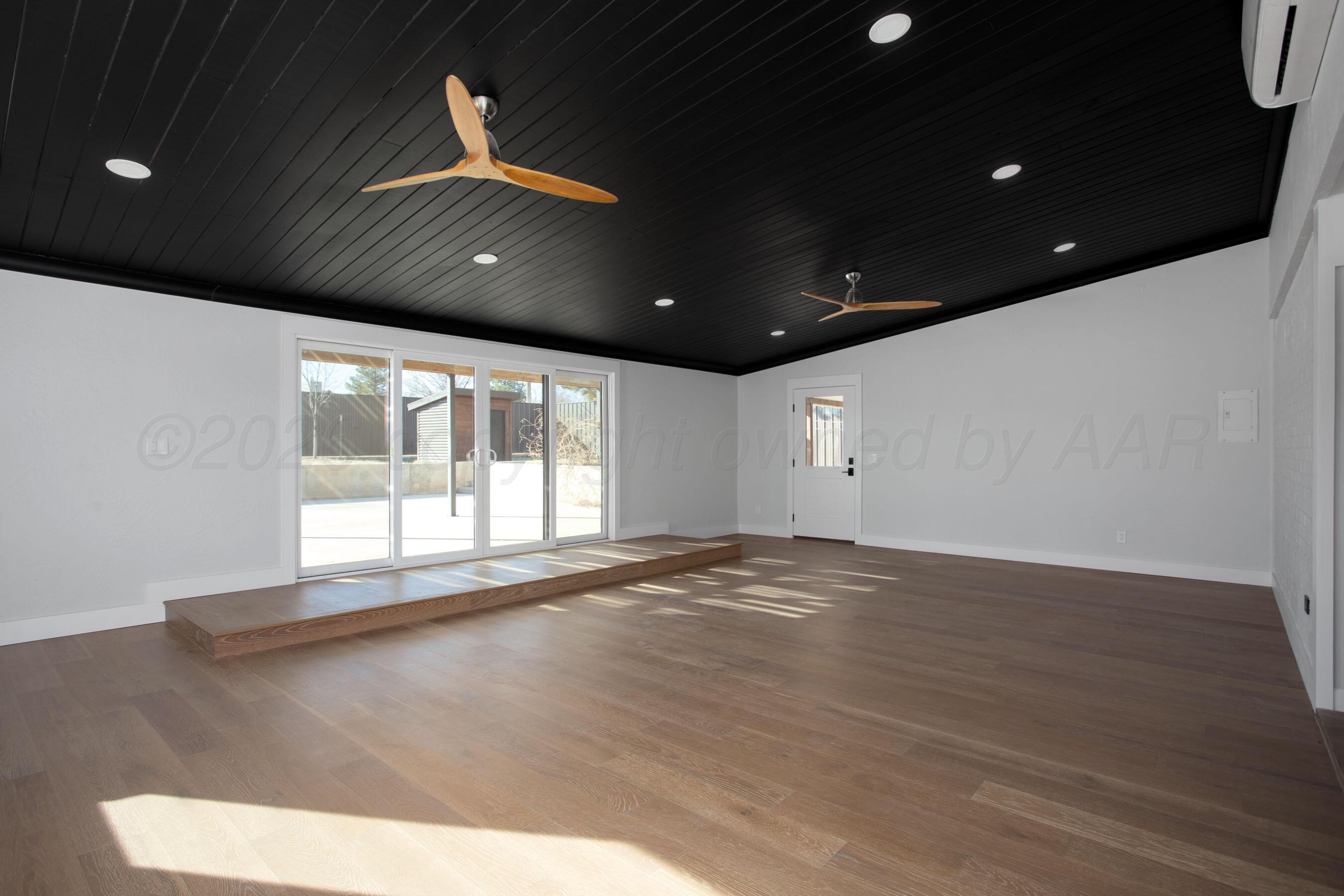 4217 West Farmers Avenue Amarillo, TX 79110 - Photo 9 of 38 an empty room with wooden floor and windows