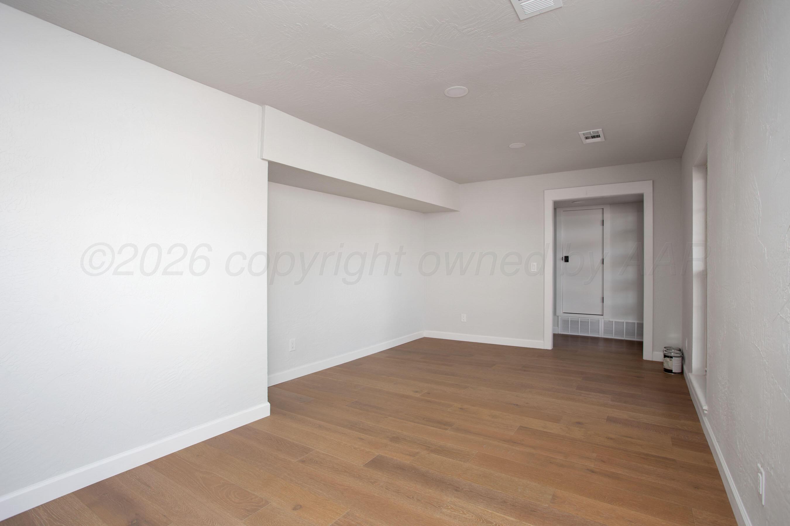 4217 West Farmers Avenue Amarillo, TX 79110 - Photo 10 of 38 a view of an empty room with wooden floor