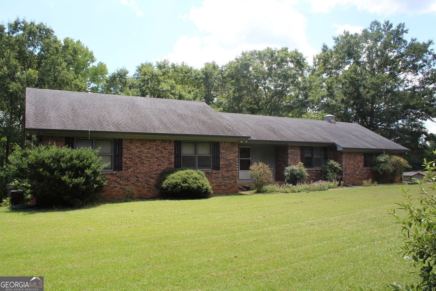 a view of house with yard and outdoor seating