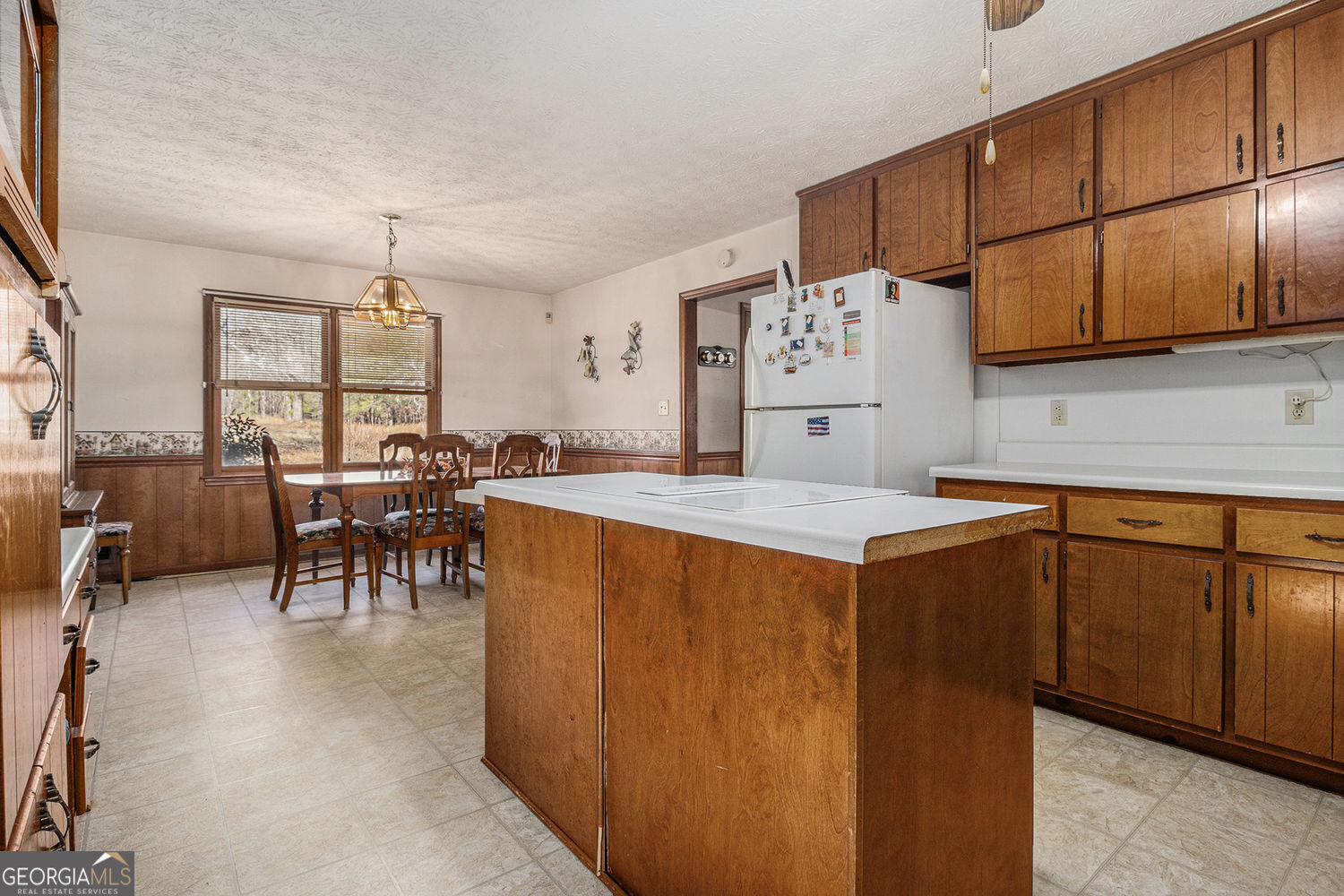 255 Barnett Road Hampton, GA 30228 - Photo 12 of 42 a kitchen with stainless steel appliances granite countertop a refrigerator a sink dishwasher a dining table and chairs with wooden floor