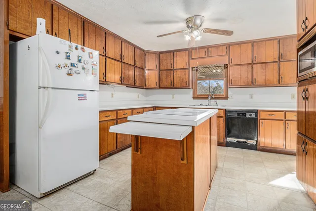 a kitchen with stainless steel appliances cabinets and a refrigerator