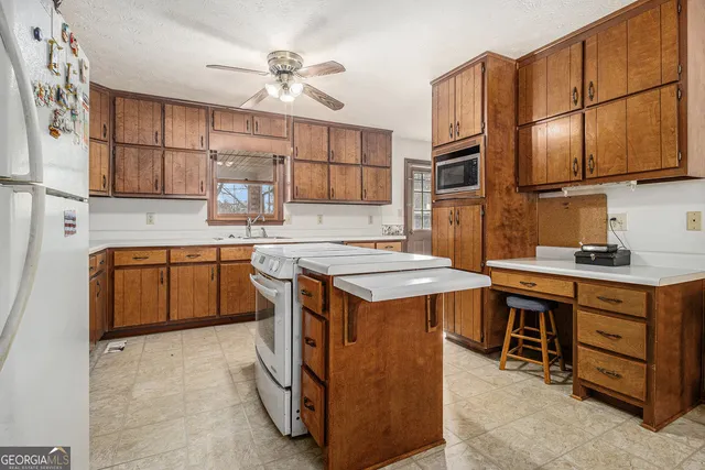 a kitchen with cabinets stainless steel appliances and a counter top space