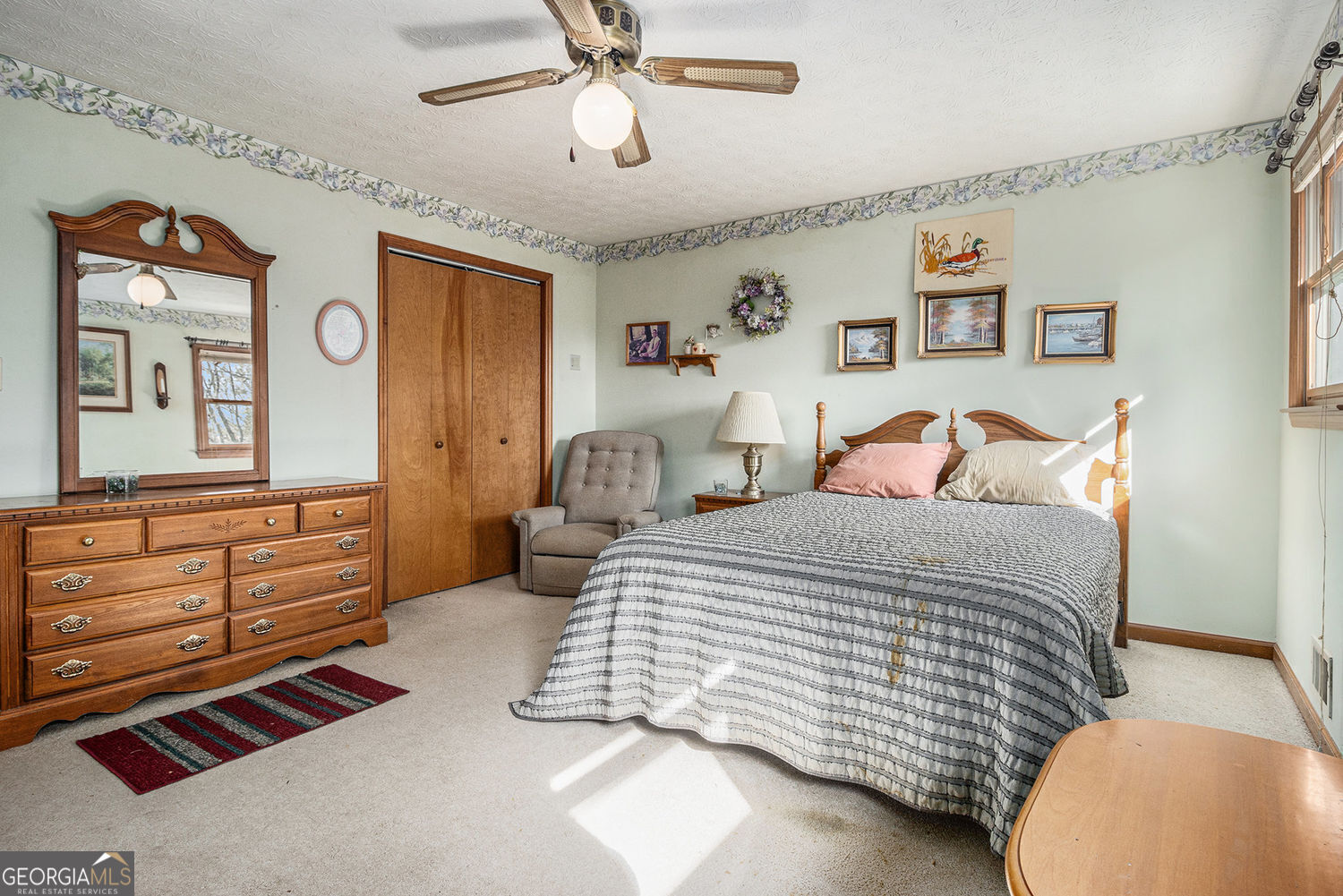 255 Barnett Road Hampton, GA 30228 - Photo 18 of 42 a bedroom with a bed and wooden floor