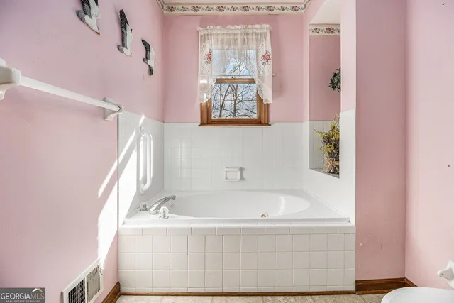 a white bath tub sitting next to a window