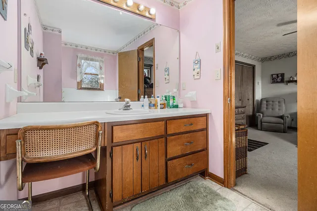 a en suite bathroom with a sink double vanity and a mirror