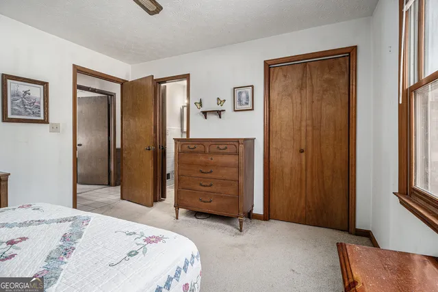 a bed room with a bed and a mirror