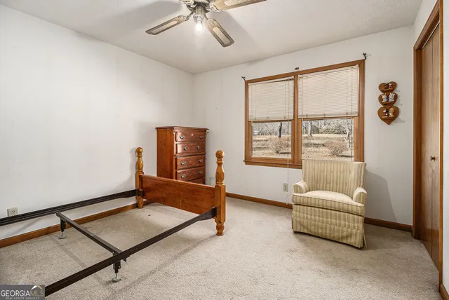 a living room with furniture gym equipment and a window