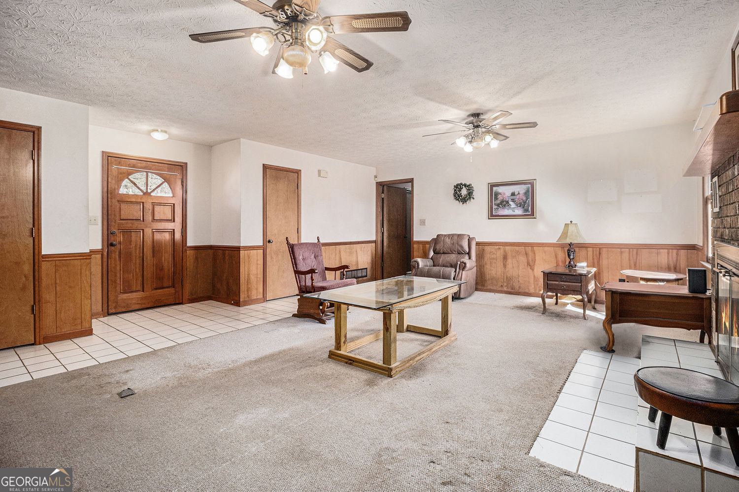 255 Barnett Road Hampton, GA 30228 - Photo 7 of 42 a living room with furniture a chandelier and a window