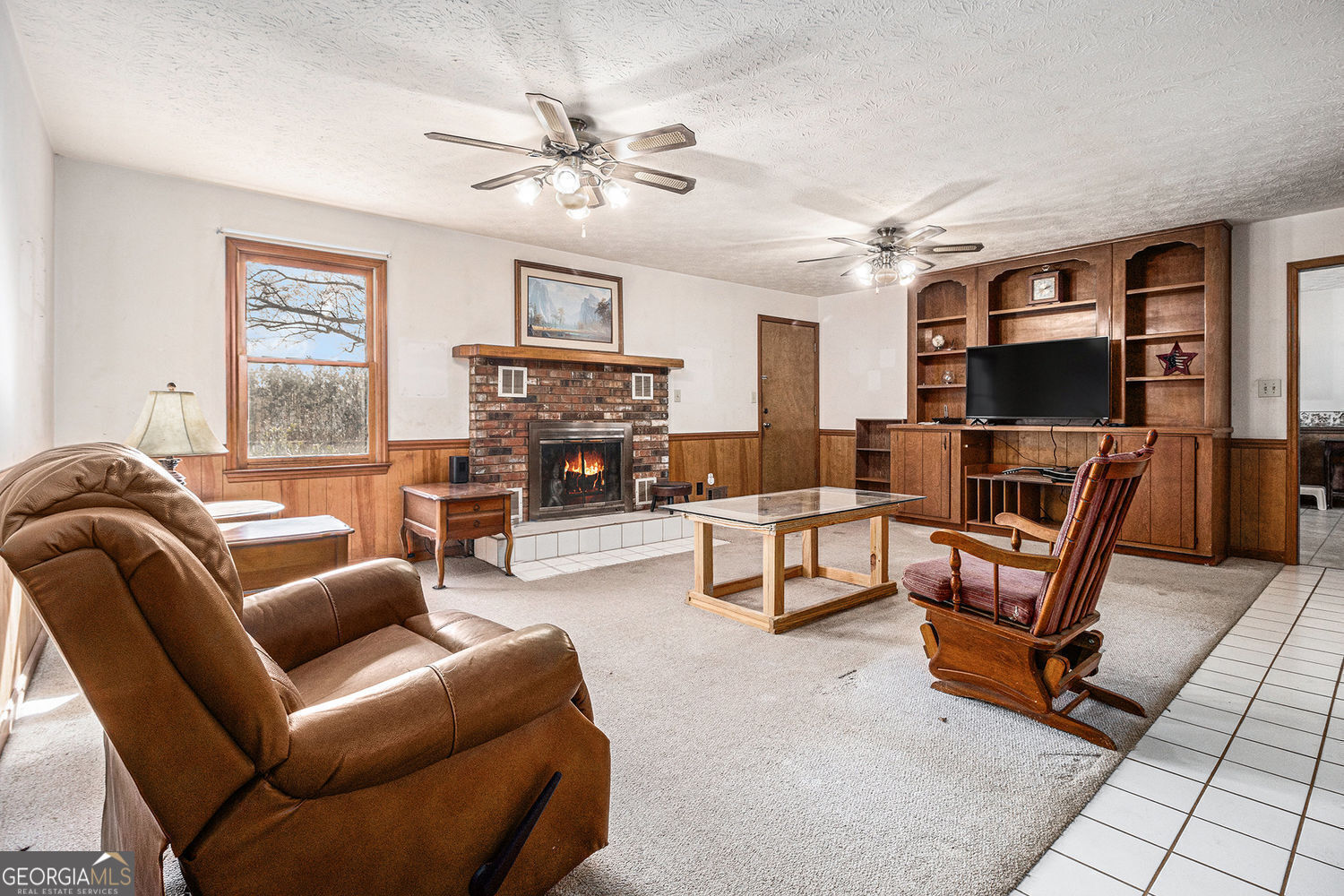 255 Barnett Road Hampton, GA 30228 - Photo 9 of 42 a living room with furniture and a flat screen tv