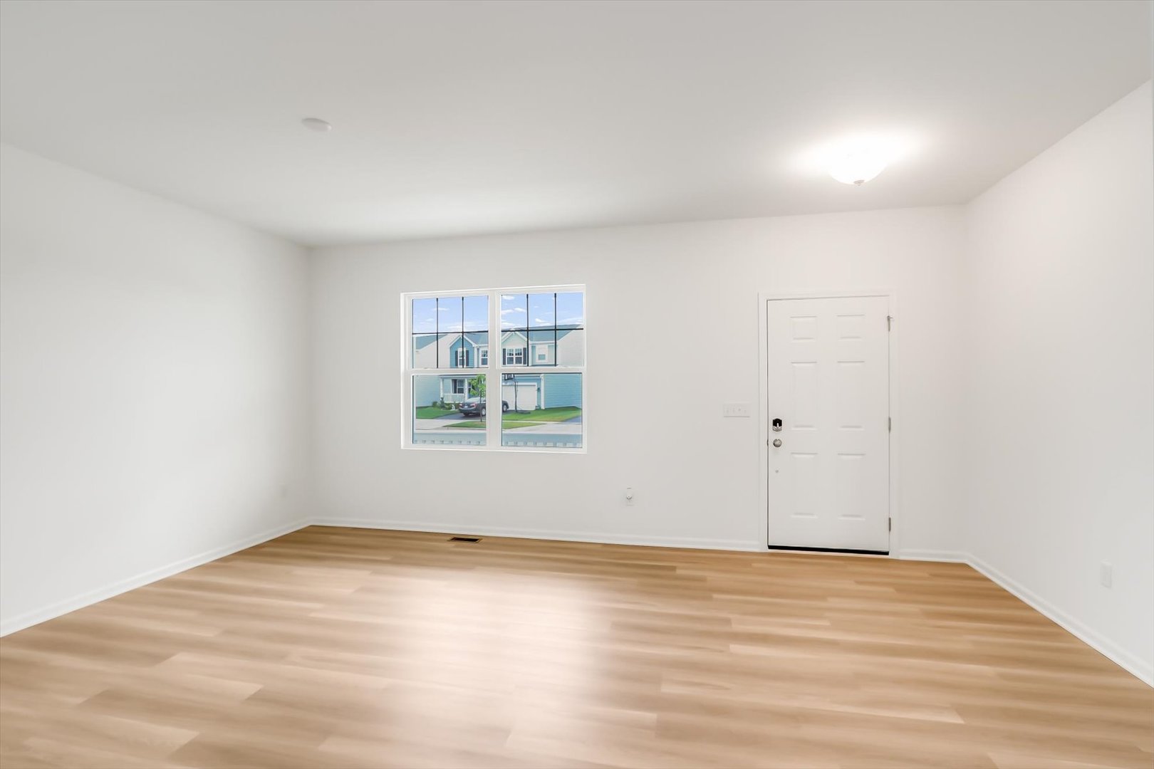 468 Endicott Road South Elgin, IL 60177 - Photo 2 of 32 an empty room with wooden floor and windows