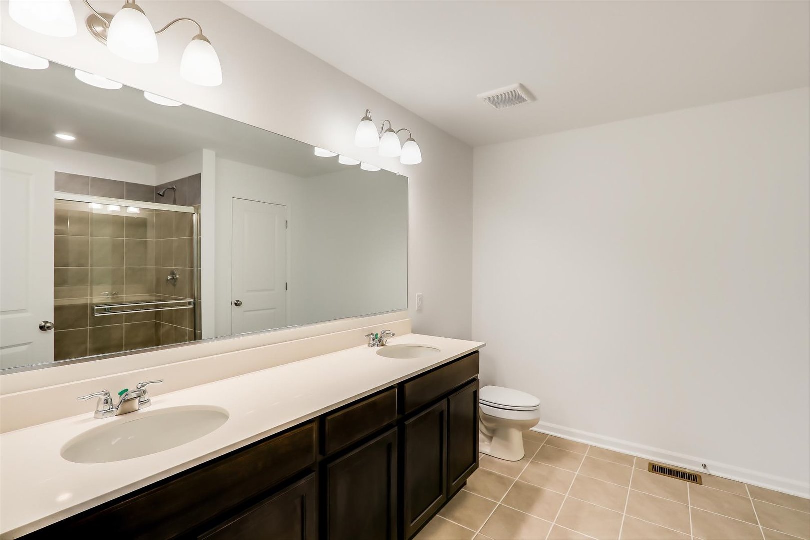 468 Endicott Road South Elgin, IL 60177 - Photo 23 of 32 a bathroom with a double vanity sink and a mirror