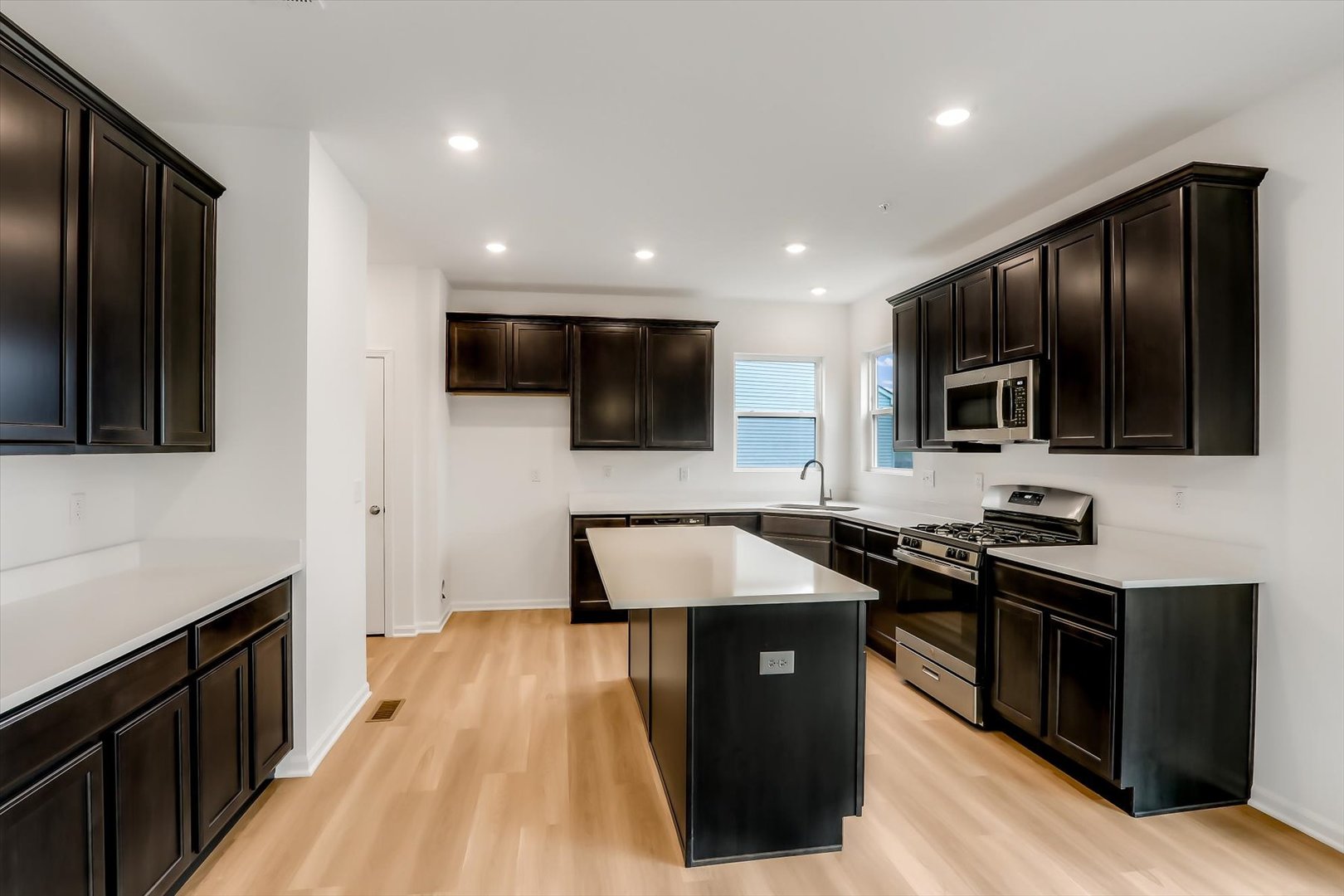 468 Endicott Road South Elgin, IL 60177 - Photo 8 of 32 a kitchen with stainless steel appliances granite countertop a stove a sink and a microwave